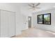 Bedroom with white wood floors, closet and window with backyard view at 3785 Lower Roswell Rd, Marietta, GA 30068
