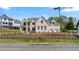 Elegant two-story home with a well-manicured lawn, wrought iron fence and neutral-toned brick exterior at 3785 Lower Roswell Rd, Marietta, GA 30068