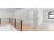 Bright hallway showcasing modern railing, wood floors, and an open doorway at 3785 Lower Roswell Rd, Marietta, GA 30068