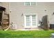 Back patio featuring double doors, a small lawn, and privacy fencing at 5590 Stonewood Court Ct, Norcross, GA 30093