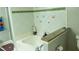 White tile lined tub with granite countertop and white orchids at 5590 Stonewood Court Ct, Norcross, GA 30093
