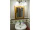 Bathroom sink with wooden framed mirror and neutral color scheme at 5590 Stonewood Court Ct, Norcross, GA 30093