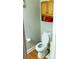 Small bathroom with laminate floors and toilet next to shelves at 5590 Stonewood Court Ct, Norcross, GA 30093