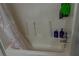 Simple bathtub and shower combination with shampoo bottles at 5590 Stonewood Court Ct, Norcross, GA 30093