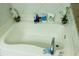 White tub with chrome faucet; decorated with white orchids at 5590 Stonewood Court Ct, Norcross, GA 30093