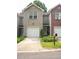 Charming townhome featuring a one-car garage and well-maintained landscaping at 5590 Stonewood Court Ct, Norcross, GA 30093