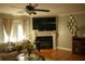Cozy living room with fireplace, hardwood floors, and a comfortable sofa at 5590 Stonewood Court Ct, Norcross, GA 30093