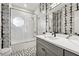 Modern bathroom with black-and-white tile, glass shower door, and updated vanity at 904 Ivy Green Se Ln, Marietta, GA 30067