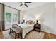 Well-lit bedroom with hardwood floors, area rug, and two windows at 904 Ivy Green Se Ln, Marietta, GA 30067