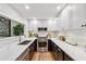 Modern kitchen featuring stainless steel appliances, marble backsplash, and quartz countertops at 904 Ivy Green Se Ln, Marietta, GA 30067
