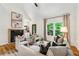 Bright living room features a fireplace, vaulted ceiling, and large windows with backyard views at 904 Ivy Green Se Ln, Marietta, GA 30067