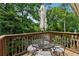 Outdoor patio with seating and umbrella, surrounded by lush greenery and mature trees at 904 Ivy Green Se Ln, Marietta, GA 30067
