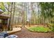 Expansive backyard features mature trees, a wooden deck, and a charming playhouse at 9176 Lakeview Pkwy, Villa Rica, GA 30180