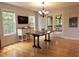 Bright dining room featuring hardwood floors, natural light, and access to a screened-in porch at 9176 Lakeview Pkwy, Villa Rica, GA 30180