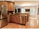 Well-equipped kitchen with stainless steel appliances, light wood cabinets, and hardwood floors at 9176 Lakeview Pkwy, Villa Rica, GA 30180