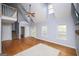 Spacious living room with high ceilings, hardwood floors, and a staircase leading to the second floor at 9176 Lakeview Pkwy, Villa Rica, GA 30180