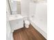 Bathroom features wood-look floors, shower-tub combo, and a white single sink vanity at 6354 Shannon Pkwy # 8B, Union City, GA 30291
