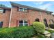 Brick townhouse exterior with red shutters and green landscaping at 6354 Shannon Pkwy # 8B, Union City, GA 30291