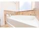 Modern soaking tub in a serene bathroom setting with tile accents, and chrome fixtures at 905 Eldridge Rd, Hampton, GA 30228