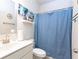 Clean bathroom featuring a single vanity, toilet, and a shower with a blue shower curtain at 905 Eldridge Rd, Hampton, GA 30228