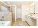 Bright bathroom with a glass-enclosed shower, double sink vanity and neutral-toned tile floor at 905 Eldridge Rd, Hampton, GA 30228
