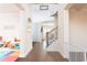 Bright foyer featuring hardwood floors, a staircase with iron railings, and views into other living spaces at 905 Eldridge Rd, Hampton, GA 30228