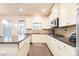 Stylish kitchen with granite countertops, stainless steel appliances, white cabinets, and hardwood flooring at 905 Eldridge Rd, Hampton, GA 30228