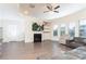 Spacious living room with hardwood floors, fireplace, a ceiling fan, and plenty of natural light at 905 Eldridge Rd, Hampton, GA 30228