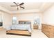 Spacious main bedroom with carpeted floors, tray ceiling, and ample natural light from the windows at 905 Eldridge Rd, Hampton, GA 30228