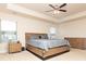 Spacious main bedroom featuring a ceiling fan, bedside table and dresser with neutral decor at 905 Eldridge Rd, Hampton, GA 30228