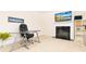 Well-lit home office with a glass desk, fireplace, and shelving for a productive workspace at 905 Eldridge Rd, Hampton, GA 30228