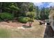 Backyard featuring a mulched hill and a patio with an outdoor seating set, perfect for relaxing outdoors at 1856 Temple Park Dr, Loganville, GA 30052