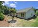 This backyard features an outdoor seating set and a mulched hill for landscaping at 1856 Temple Park Dr, Loganville, GA 30052
