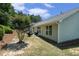 Backyard featuring a mulched hill and a patio with an outdoor seating set, perfect for relaxing outdoors at 1856 Temple Park Dr, Loganville, GA 30052
