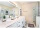 Bright bathroom featuring double sinks, a glass-enclosed shower, and modern fixtures at 1856 Temple Park Dr, Loganville, GA 30052