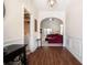 Inviting hallway with rich wood flooring and arched entryway leading to the living area at 1856 Temple Park Dr, Loganville, GA 30052