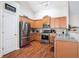 Modern kitchen with stainless steel appliances, wooden cabinets, and durable countertops at 1856 Temple Park Dr, Loganville, GA 30052