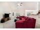 Spacious living room with high ceilings, plush carpeting, and a comfortable red sectional sofa at 1856 Temple Park Dr, Loganville, GA 30052