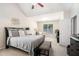 Comfortable bedroom with a large window, ceiling fan and a sitting area at 1856 Temple Park Dr, Loganville, GA 30052