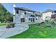 This backyard features a white house with a concrete patio with a playground at 2035 Lena Carter Rd, Buford, GA 30519