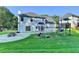 This backyard features a white house with a concrete patio with a playground at 2035 Lena Carter Rd, Buford, GA 30519