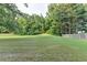 Large backyard with a tree line at 2035 Lena Carter Rd, Buford, GA 30519