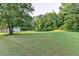 Large backyard with a large tree at 2035 Lena Carter Rd, Buford, GA 30519