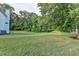 Large backyard with a tree line and house at 2035 Lena Carter Rd, Buford, GA 30519
