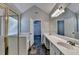 A bright bathroom featuring double sinks, shower, and access to the bedroom at 2035 Lena Carter Rd, Buford, GA 30519