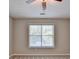 Cozy bedroom features neutral paint, a ceiling fan, carpet and a sunlit window at 2035 Lena Carter Rd, Buford, GA 30519
