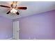 Bedroom features light purple walls, carpet, a ceiling fan, and a single window at 2035 Lena Carter Rd, Buford, GA 30519