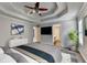 The bedroom features a tray ceiling, windows, and neutral paint at 2035 Lena Carter Rd, Buford, GA 30519