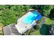 Aerial view of a sparkling community pool with ample lounge seating and a covered area, surrounded by lush greenery at 2035 Lena Carter Rd, Buford, GA 30519
