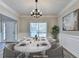 Virtually staged dining room with seating for eight people with a view of the front door and entryway at 2035 Lena Carter Rd, Buford, GA 30519